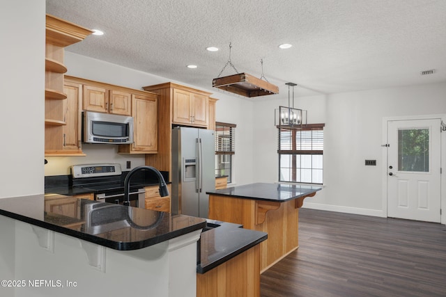 2871 Anchor Rd, Middleburg, FL 32068 - kitchen with stainless steel appliances, open shelves, a textured ceiling, plenty of natural light, and a kitchen bar
