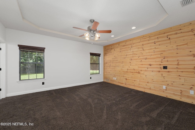 2871 Anchor Rd, Middleburg, FL 32068 - unfurnished room featuring a tray ceiling, ceiling fan, dark colored carpet, wood walls, and recessed lighting