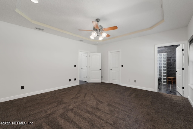 2871 Anchor Rd, Middleburg, FL 32068 - unfurnished bedroom with a raised ceiling, dark colored carpet, and connected bathroom