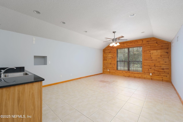 2871 Anchor Rd, Middleburg, FL 32068 - unfurnished living room with lofted ceiling, wood walls, ceiling fan, a textured ceiling, and light tile patterned floors