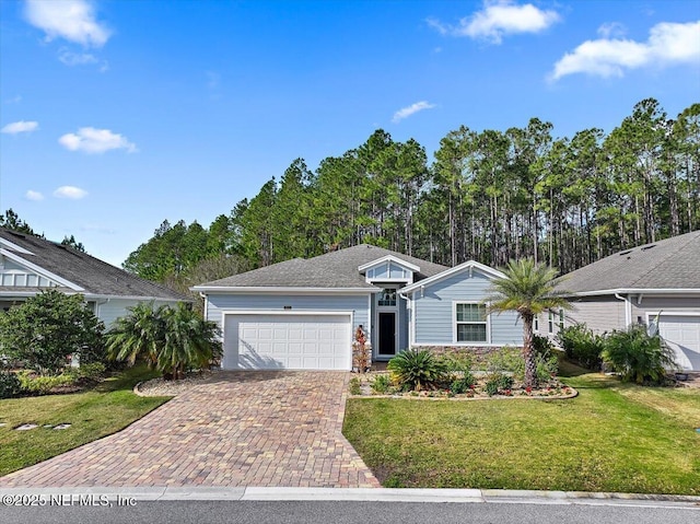 102 Anguilla Blvd, Saint Augustine, FL 32092 - ranch-style house with decorative driveway, a garage, and a front lawn