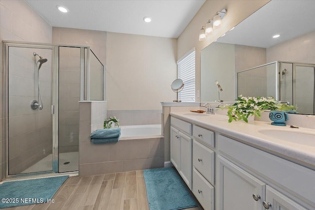102 Anguilla Blvd, Saint Augustine, FL 32092 - full bathroom featuring a stall shower, a bath, double vanity, wood finish floors, and recessed lighting
