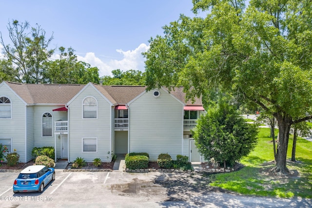 2300 Twelve Oaks Dr Unit K-14, Orange Park, FL 32065 - view of property featuring uncovered parking and a shingled roof