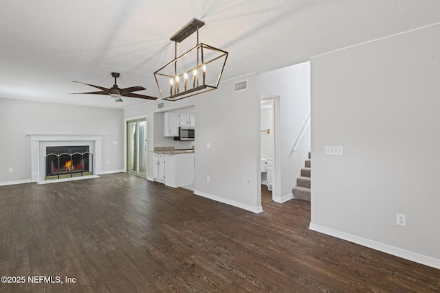 2300 Twelve Oaks Dr Unit K-14, Orange Park, FL 32065 - unfurnished living room with ceiling fan, stairway, dark wood finished floors, a chandelier, and a textured ceiling