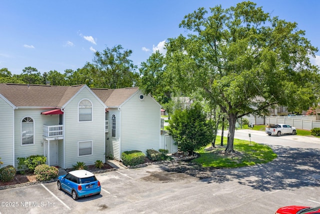 2300 Twelve Oaks Dr Unit K-14, Orange Park, FL 32065 - view of home's exterior with uncovered parking and a shingled roof