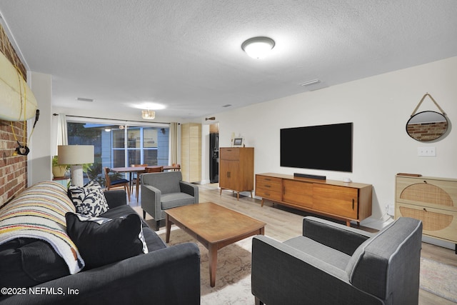 239 Glynlea Rd, Jacksonville, FL 32216 - living area with a textured ceiling and light wood-style floors