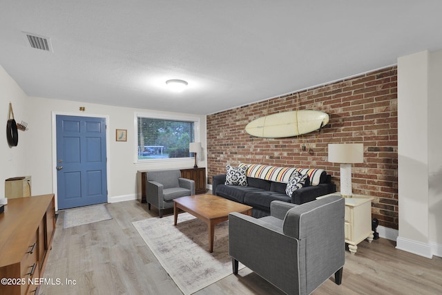 239 Glynlea Rd, Jacksonville, FL 32216 - living area featuring light wood-type flooring and brick wall