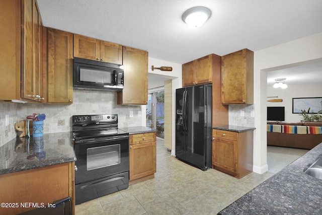 239 Glynlea Rd, Jacksonville, FL 32216 - kitchen featuring black appliances, decorative backsplash, brown cabinets, and dark stone countertops