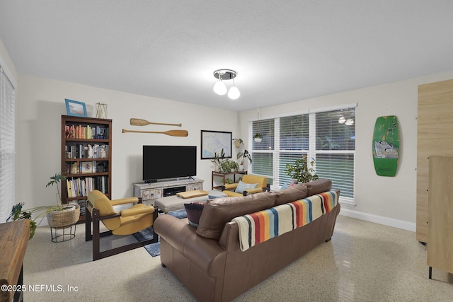 239 Glynlea Rd, Jacksonville, FL 32216 - living room featuring baseboards and dark aggregate flooring