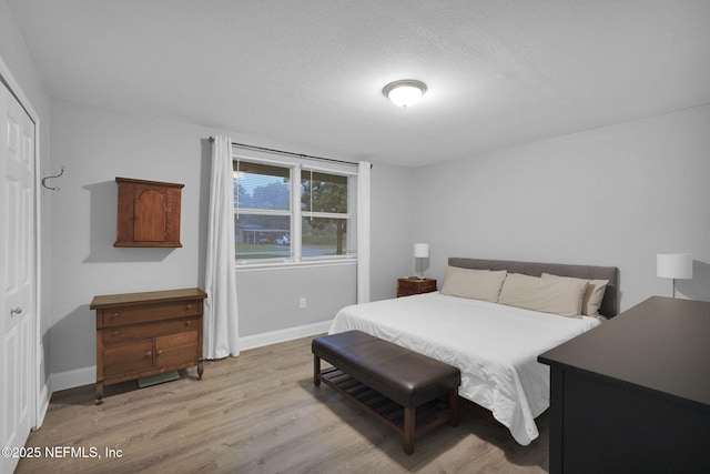 239 Glynlea Rd, Jacksonville, FL 32216 - bedroom with light wood finished floors and a textured ceiling