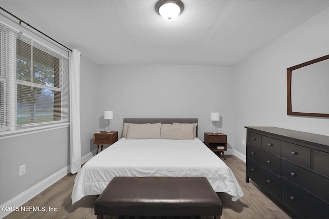 239 Glynlea Rd, Jacksonville, FL 32216 - bedroom with wood finished floors and a textured ceiling