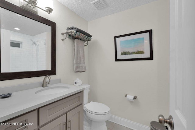 239 Glynlea Rd, Jacksonville, FL 32216 - bathroom with a textured ceiling, vanity, tile patterned flooring, and a tile shower