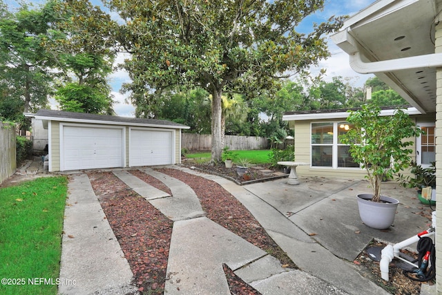 239 Glynlea Rd, Jacksonville, FL 32216 - view of patio / terrace featuring an outbuilding and a garage