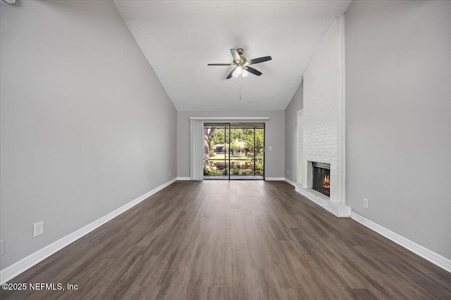 404 Villa Del Mar Dr Unit J-4, Ponte Vedra Beach, FL 32082 - unfurnished living room with lofted ceiling, a ceiling fan, dark wood-style floors, and a brick fireplace