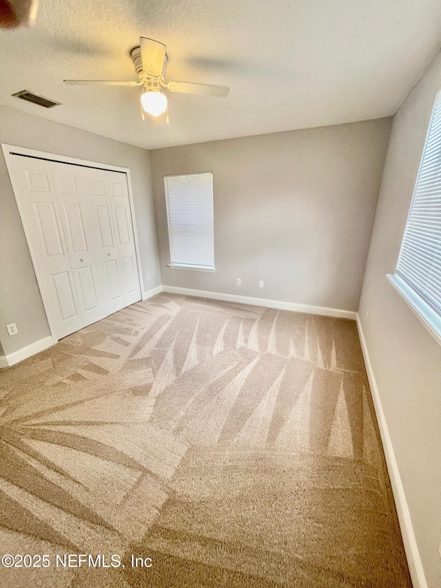 86069 Pineview Dr, Yulee, FL 32097 - unfurnished bedroom featuring carpet flooring, a closet, and ceiling fan