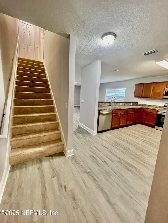 86069 Pineview Dr, Yulee, FL 32097 - staircase with wood finished floors and a textured ceiling