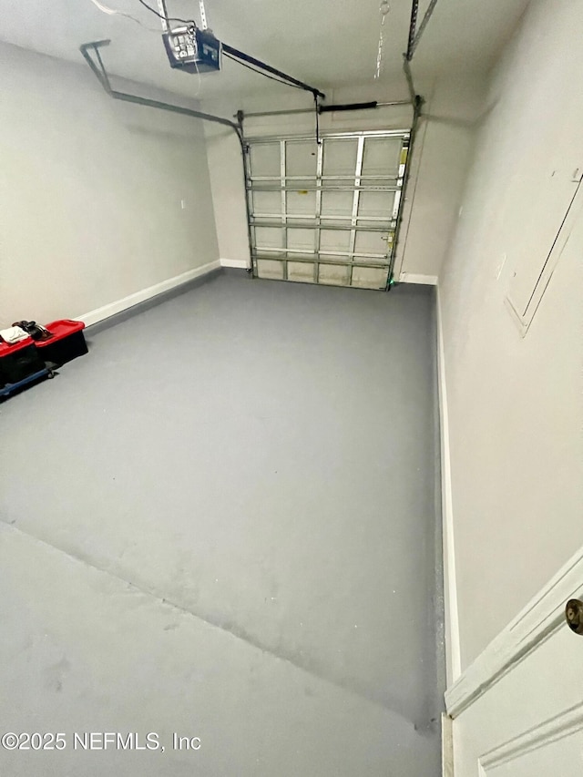 86069 Pineview Dr, Yulee, FL 32097 - garage featuring a garage door opener and baseboards
