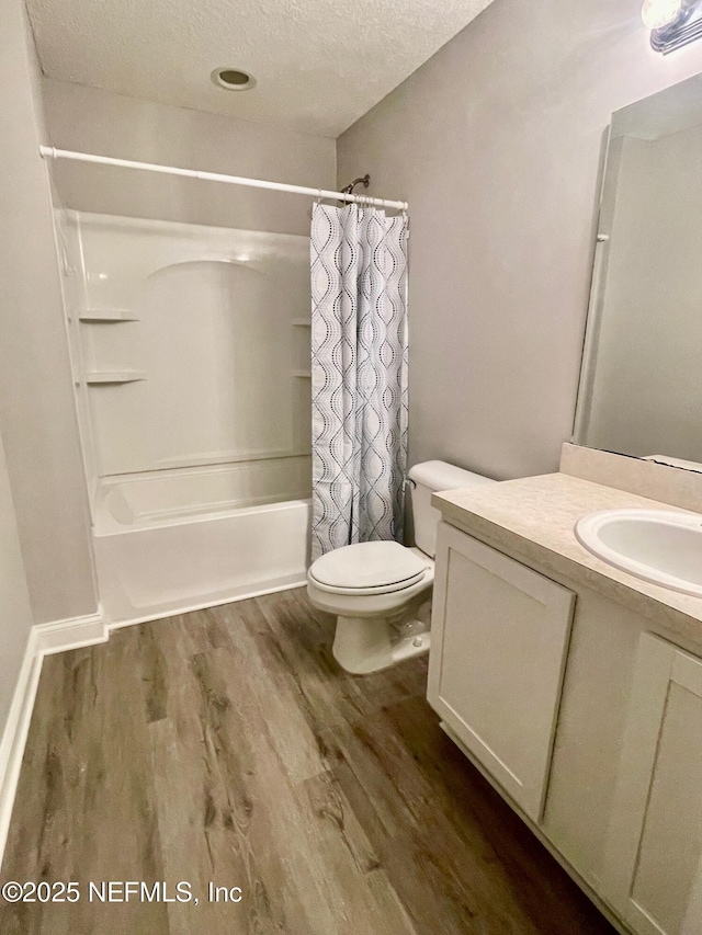 86069 Pineview Dr, Yulee, FL 32097 - bathroom with vanity, wood finished floors, shower / bathtub combination with curtain, and a textured ceiling