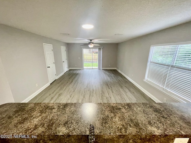 86069 Pineview Dr, Yulee, FL 32097 - empty room with a ceiling fan, wood finished floors, and a textured ceiling
