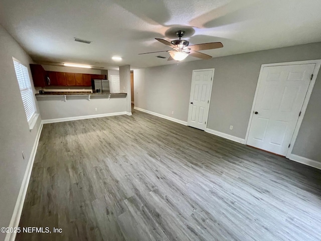 86069 Pineview Dr, Yulee, FL 32097 - unfurnished living room featuring dark wood-style flooring and a ceiling fan