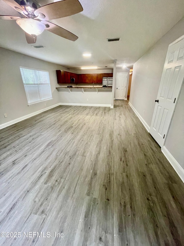 86069 Pineview Dr, Yulee, FL 32097 - unfurnished living room with dark wood-style floors and a ceiling fan