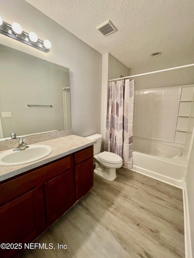 86069 Pineview Dr, Yulee, FL 32097 - bathroom with wood finished floors, vanity, shower / bathtub combination with curtain, and a textured ceiling