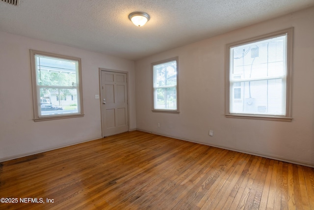 3312 Dellwood Ave, Jacksonville, FL 32205 - spare room with light wood-style floors, plenty of natural light, and a textured ceiling