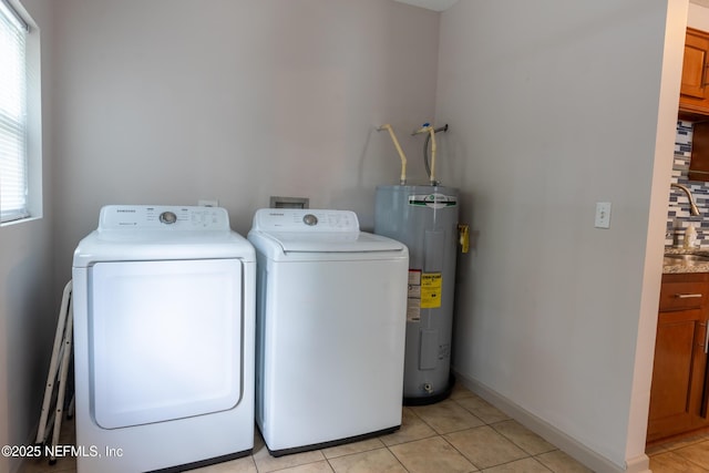 3312 Dellwood Ave, Jacksonville, FL 32205 - washroom with electric water heater, washing machine and dryer, and light tile patterned flooring