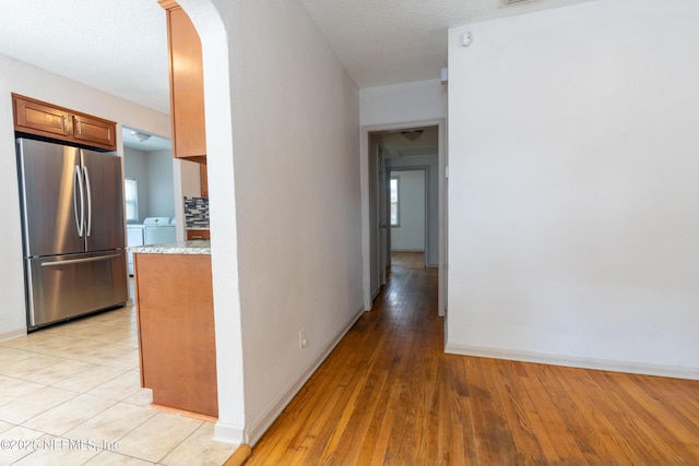 3312 Dellwood Ave, Jacksonville, FL 32205 - hallway with washer / clothes dryer, arched walkways, and light wood-style floors