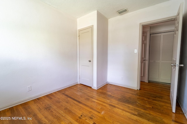 3312 Dellwood Ave, Jacksonville, FL 32205 - unfurnished bedroom with wood finished floors and a textured ceiling