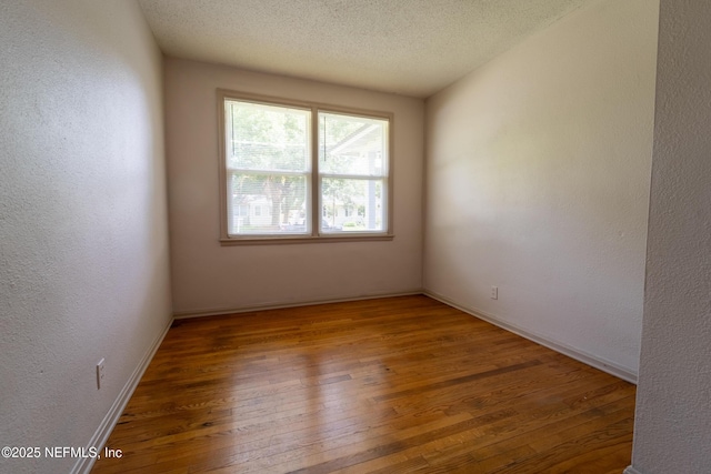 3312 Dellwood Ave, Jacksonville, FL 32205 - spare room featuring hardwood / wood-style floors, a textured wall, and a textured ceiling