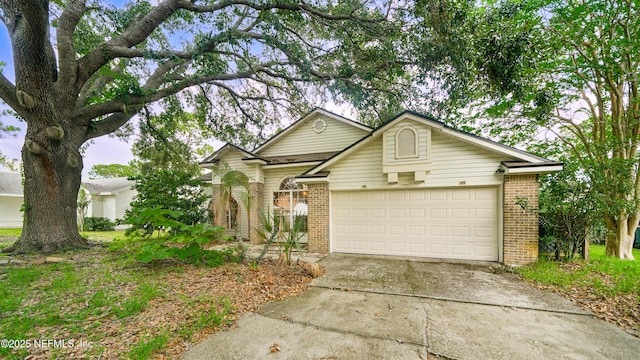 2109 Hovington Cir W, Jacksonville, FL 32246 - view of front of house with brick siding, driveway, and an attached garage