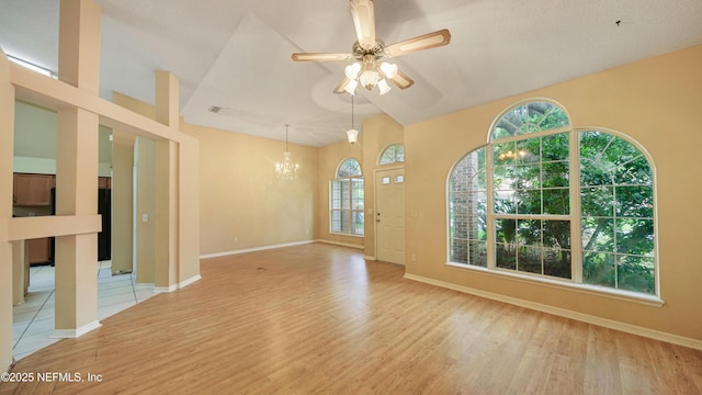 2109 Hovington Cir W, Jacksonville, FL 32246 - unfurnished living room featuring a chandelier, light wood finished floors, a ceiling fan, and vaulted ceiling