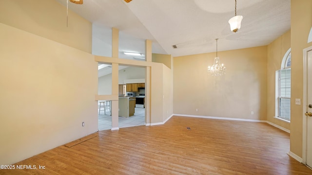 2109 Hovington Cir W, Jacksonville, FL 32246 - spare room featuring light wood-type flooring, healthy amount of natural light, a chandelier, and high vaulted ceiling