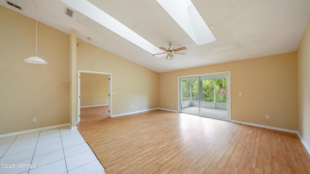 2109 Hovington Cir W, Jacksonville, FL 32246 - unfurnished room featuring a skylight, light wood-type flooring, lofted ceiling, and ceiling fan
