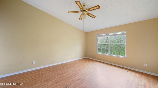 2109 Hovington Cir W, Jacksonville, FL 32246 - spare room with lofted ceiling, light wood-type flooring, ceiling fan, and a textured ceiling