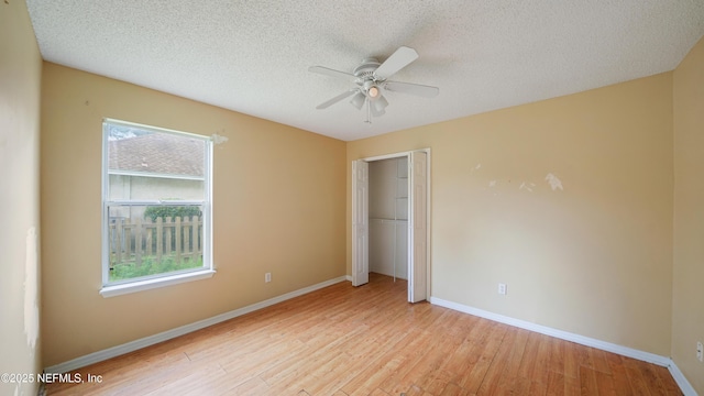 2109 Hovington Cir W, Jacksonville, FL 32246 - unfurnished bedroom with light wood-type flooring, a closet, a textured ceiling, and ceiling fan