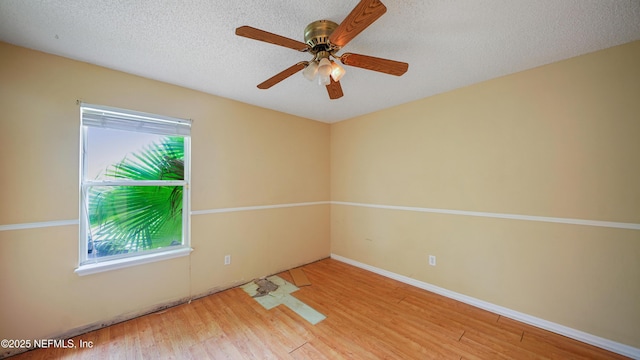 2109 Hovington Cir W, Jacksonville, FL 32246 - unfurnished room with wood finished floors, healthy amount of natural light, a ceiling fan, and a textured ceiling