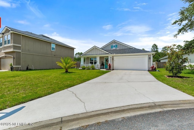 75078 Glenspring Way, Yulee, FL 32097 - view of front of property with a front lawn, a garage, driveway, and covered porch