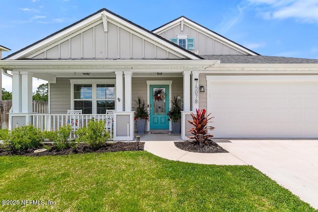 75078 Glenspring Way, Yulee, FL 32097 - view of front of house with board and batten siding, concrete driveway, a porch, a front lawn, and a garage