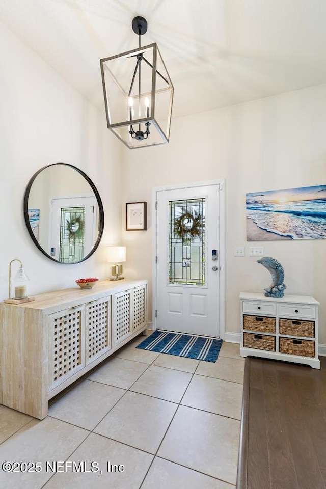 75078 Glenspring Way, Yulee, FL 32097 - entrance foyer with light tile patterned floors and a chandelier