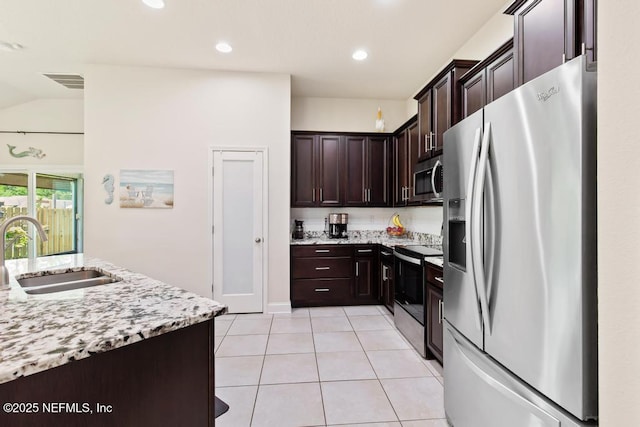 75078 Glenspring Way, Yulee, FL 32097 - kitchen featuring appliances with stainless steel finishes, dark brown cabinets, light tile patterned flooring, light stone countertops, and recessed lighting