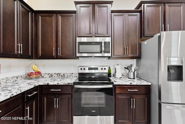 75078 Glenspring Way, Yulee, FL 32097 - kitchen featuring appliances with stainless steel finishes, backsplash, light stone countertops, and dark brown cabinets