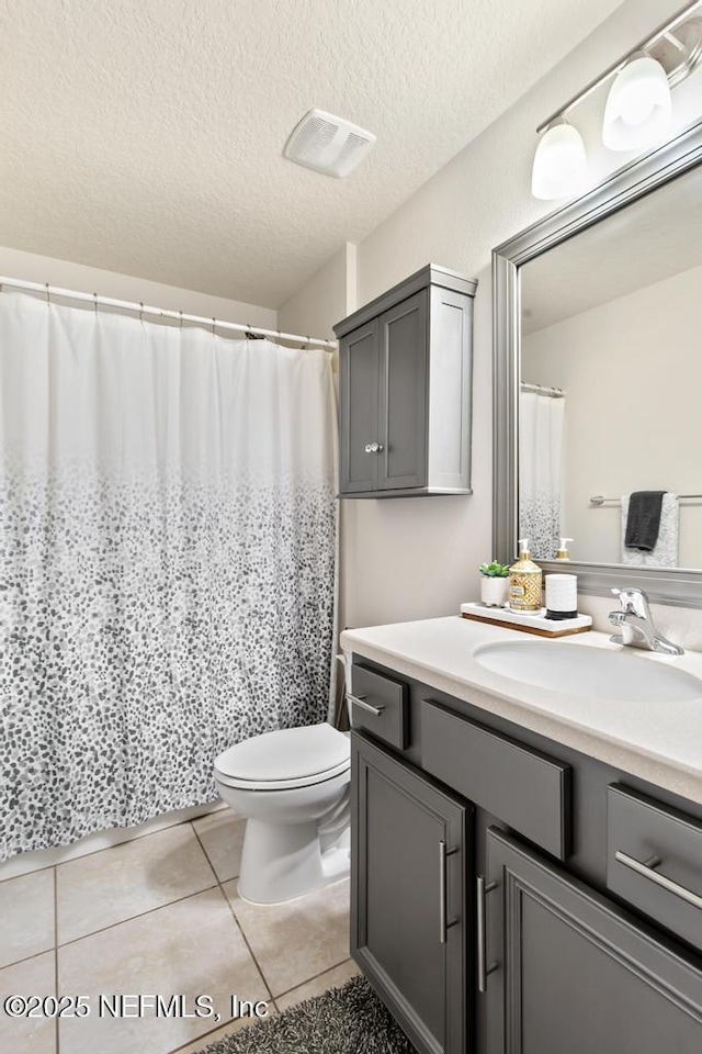 75078 Glenspring Way, Yulee, FL 32097 - bathroom with vanity, tile patterned floors, and a textured ceiling