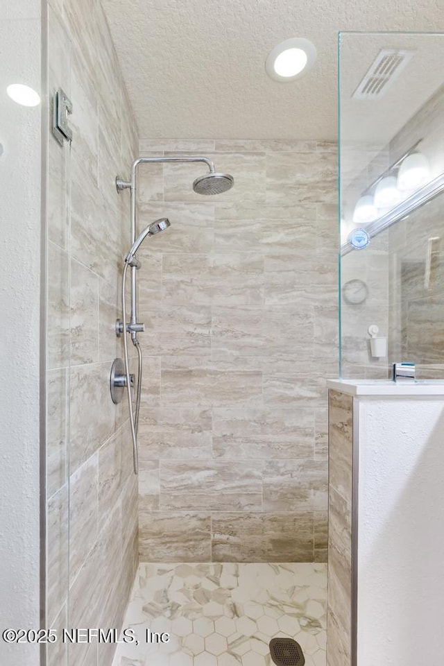 75078 Glenspring Way, Yulee, FL 32097 - full bath with a tile shower and a textured ceiling