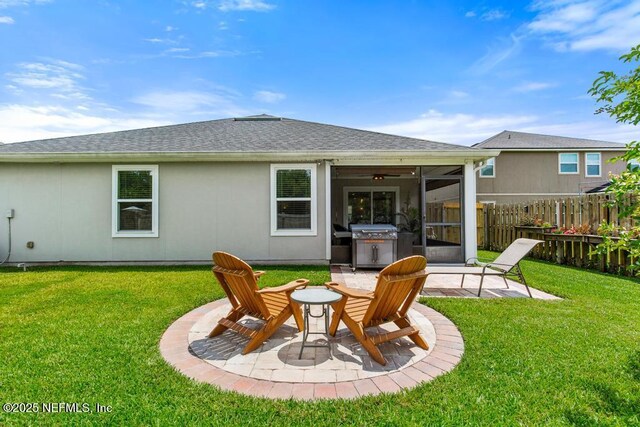 75078 Glenspring Way, Yulee, FL 32097 - rear view of house featuring a sunroom, a patio, and a shingled roof