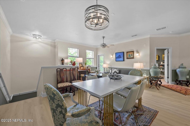 25 Riverview Bnd N Unit 122, Palm Coast, FL 32137 - dining room with light wood-style floors, ornamental molding, a chandelier, and a ceiling fan