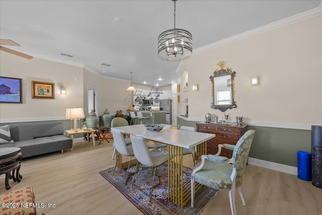 25 Riverview Bnd N Unit 122, Palm Coast, FL 32137 - dining room with ornamental molding, light wood-style floors, and a chandelier