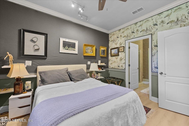 25 Riverview Bnd N Unit 122, Palm Coast, FL 32137 - bedroom featuring ornamental molding, wallpapered walls, wood finished floors, connected bathroom, and ceiling fan