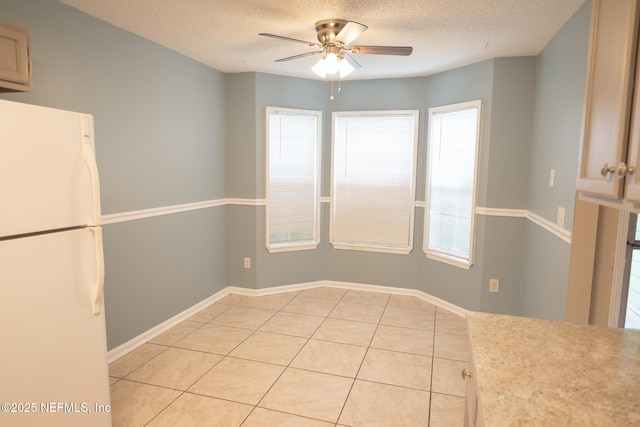 3013 Wavering Ln, Middleburg, FL 32068 - unfurnished dining area with a ceiling fan, light tile patterned flooring, and a textured ceiling